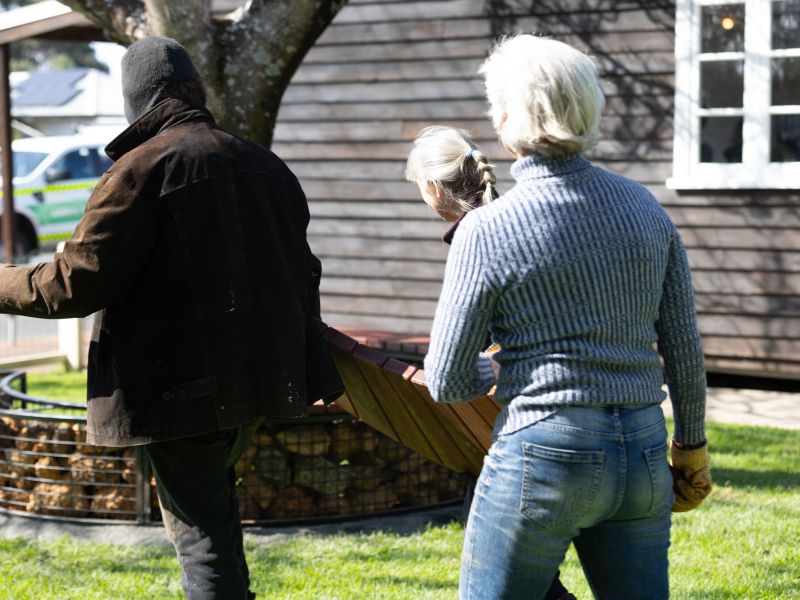 Jarrah tops of gabion seating being carried by community